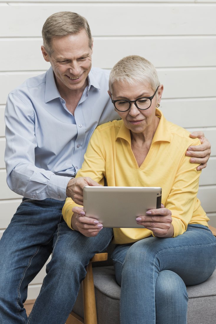 Couple at home looking over their project on a tablet